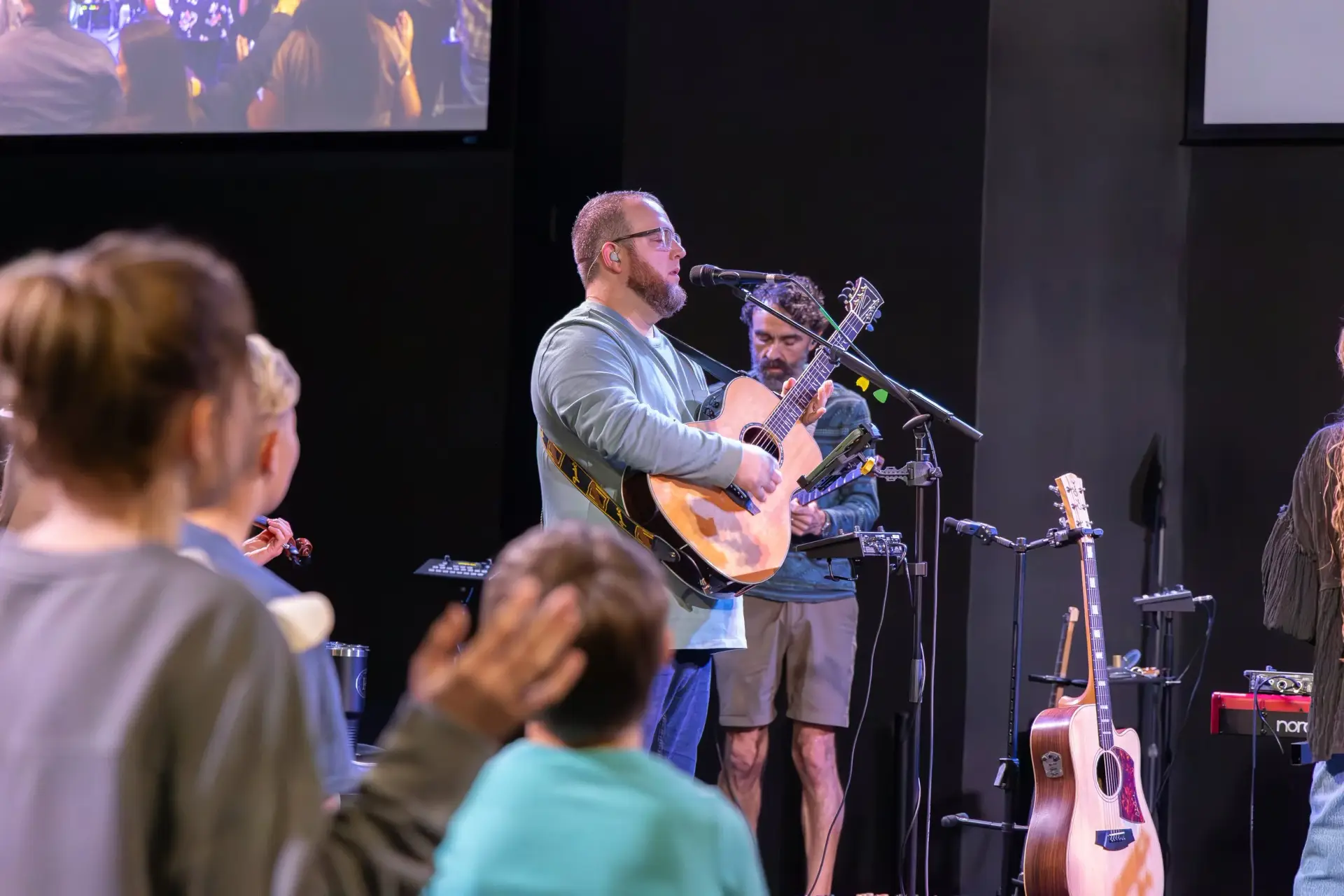 Worship leader singing and playing guitar at The Homestead in Mobile Alabama with upgraded church sound system
