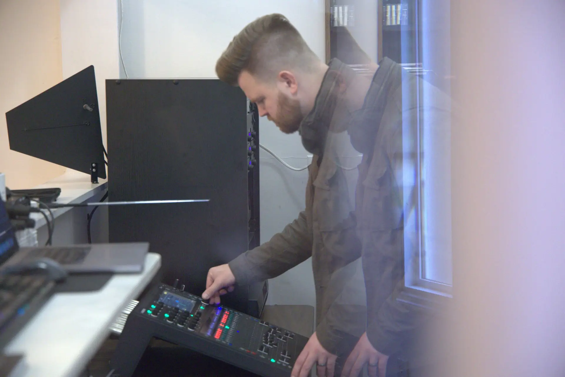 Presence Pro Audio owner Hunter Mikelson configuring a professional audio mixing console during a church AV system setup