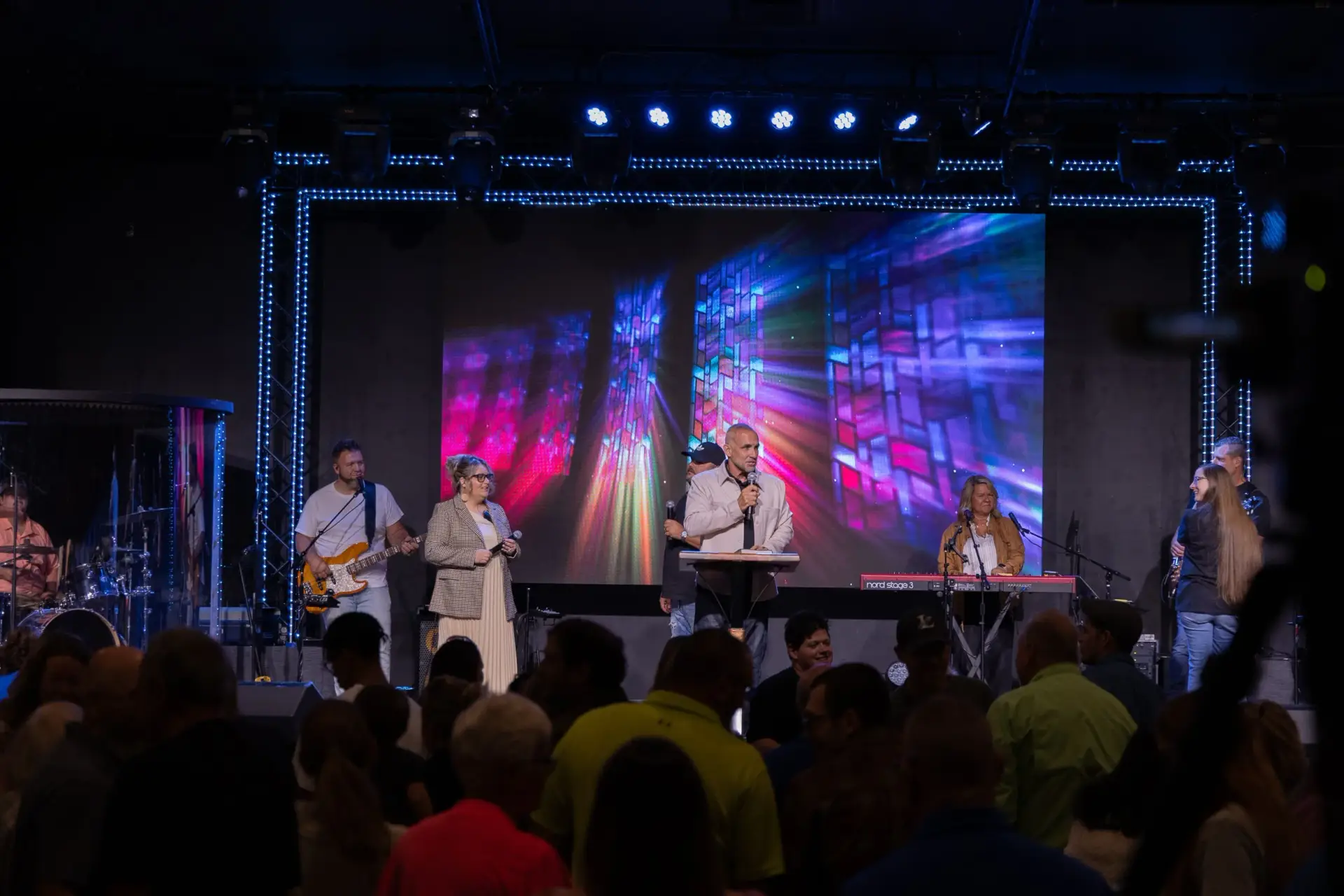 Pastor speaking on stage with full church AVL system installed by Presence Pro Audio at Fellowship of Praise in Clarksville Ohio