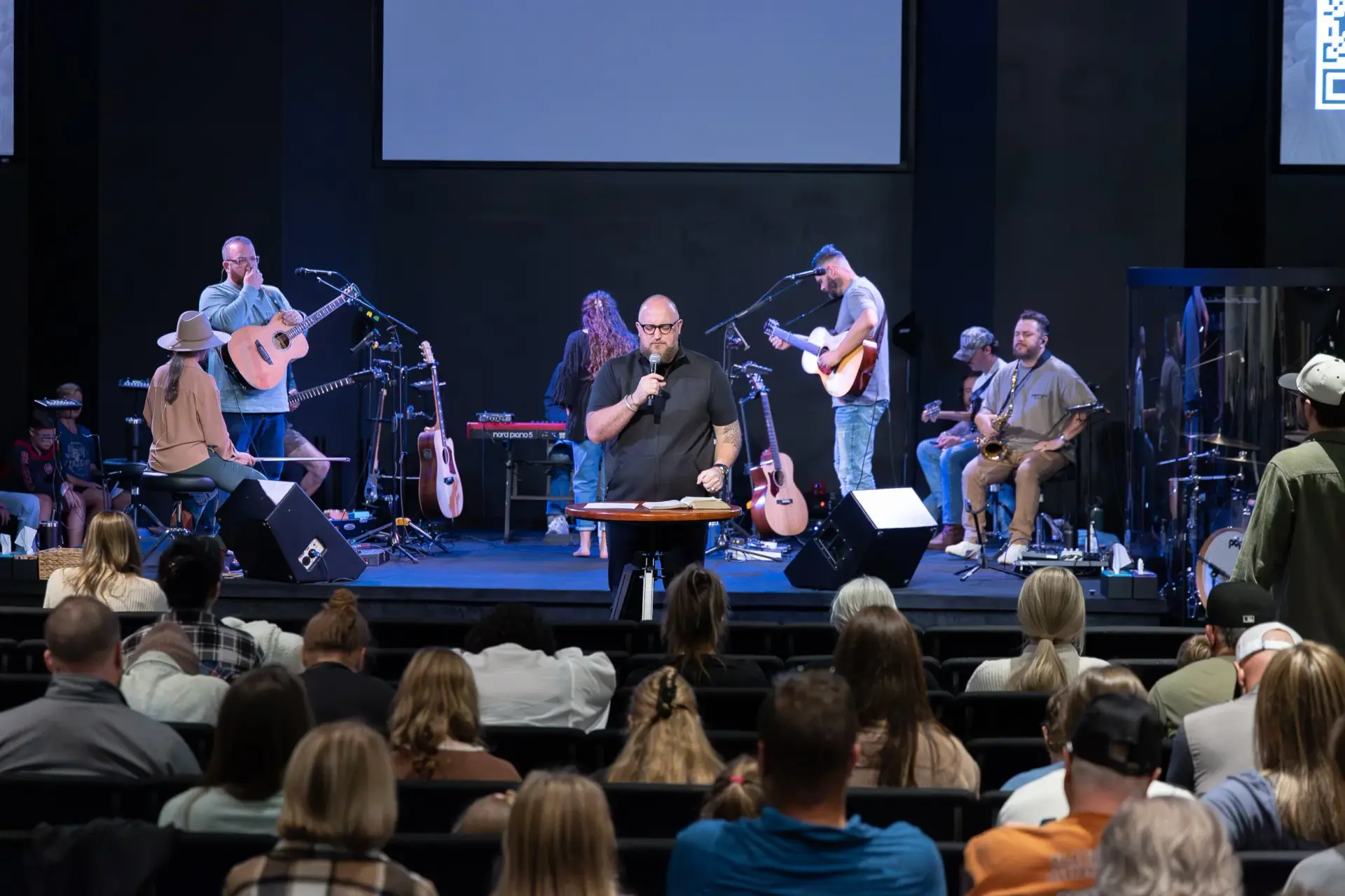 Pastor speaking to congregation at The Homestead in Mobile Alabama with worship band and AVL system installed by Presence Pro Audio