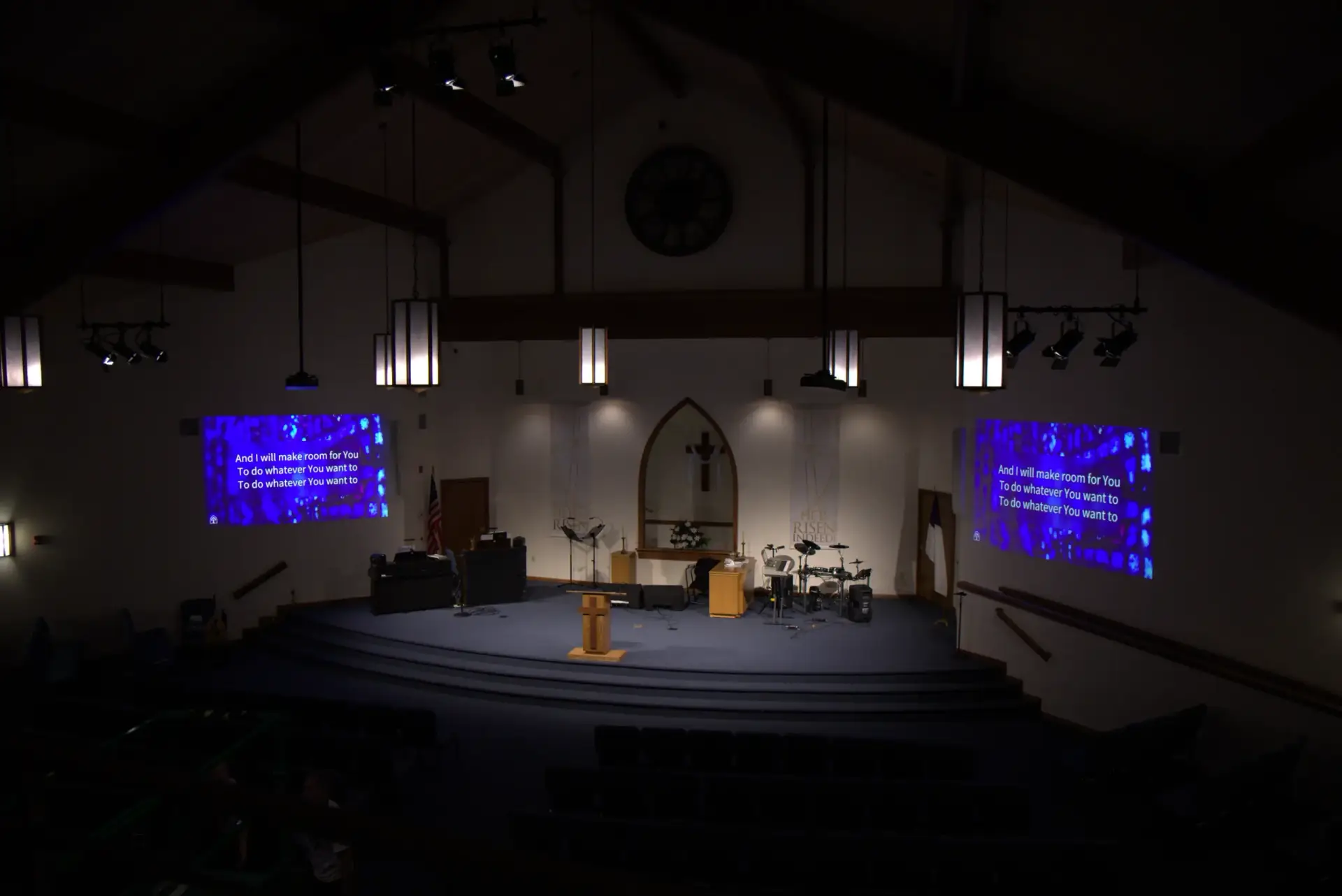 Church sanctuary ceiling with mounted projectors and new stage lighting fixtures