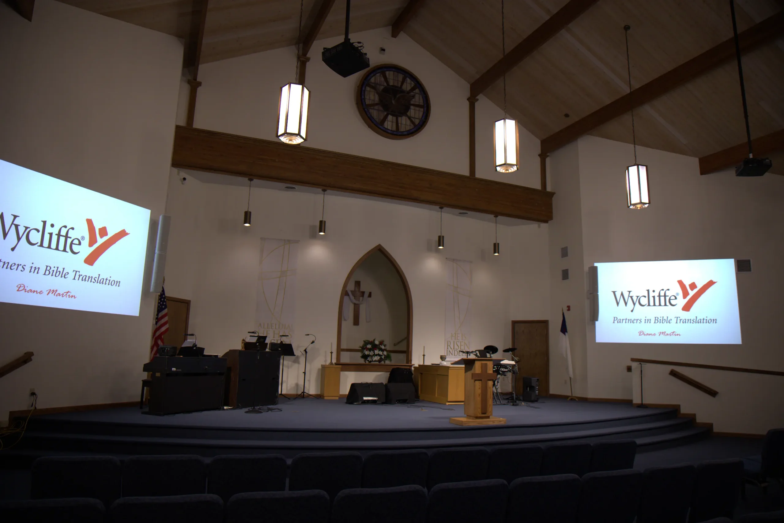 Church sanctuary with dual projection screens and stage lighting before service