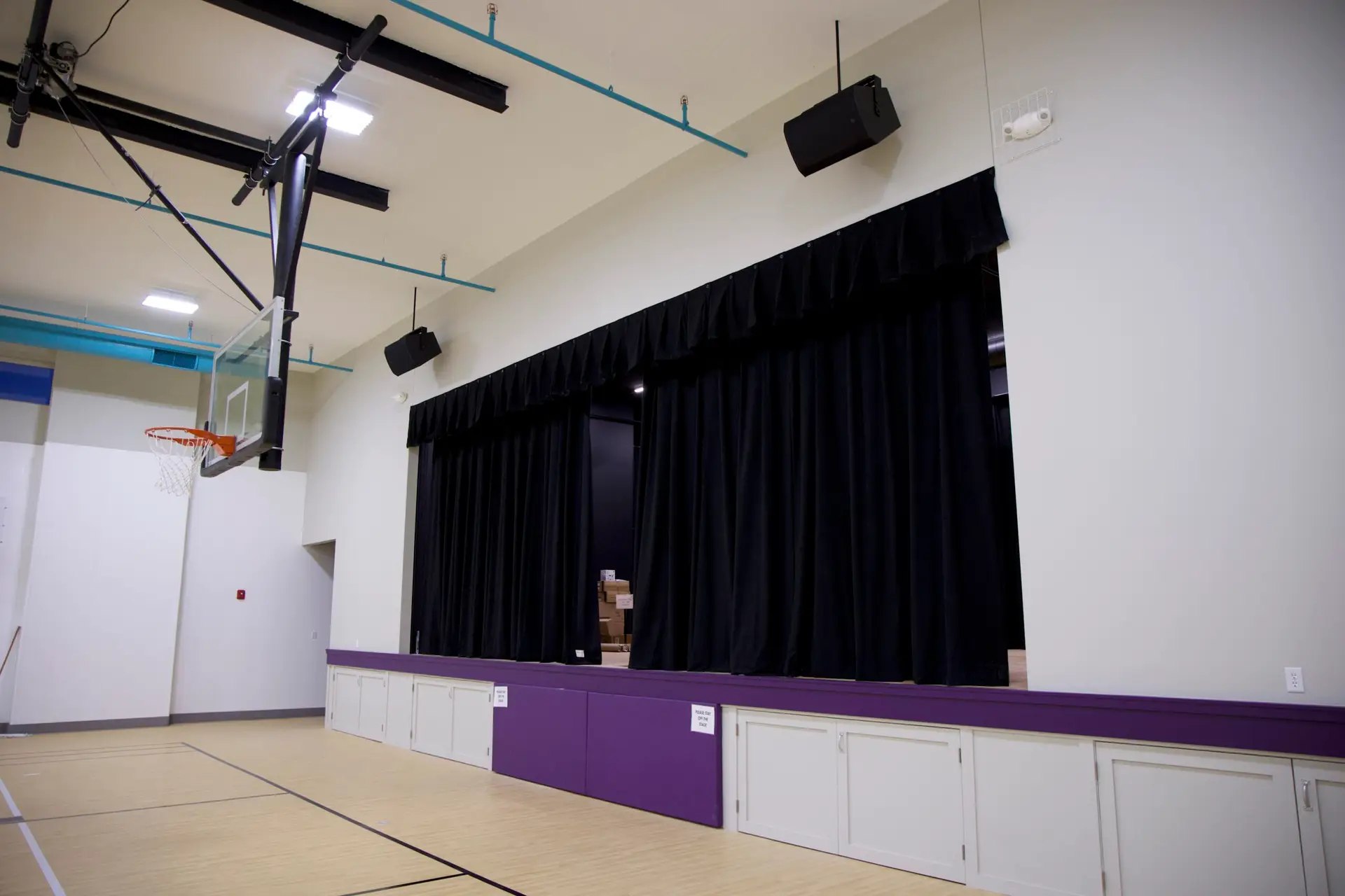 EV-C loudspeaker suspended in Covenant Christian School gymnasium auditorium