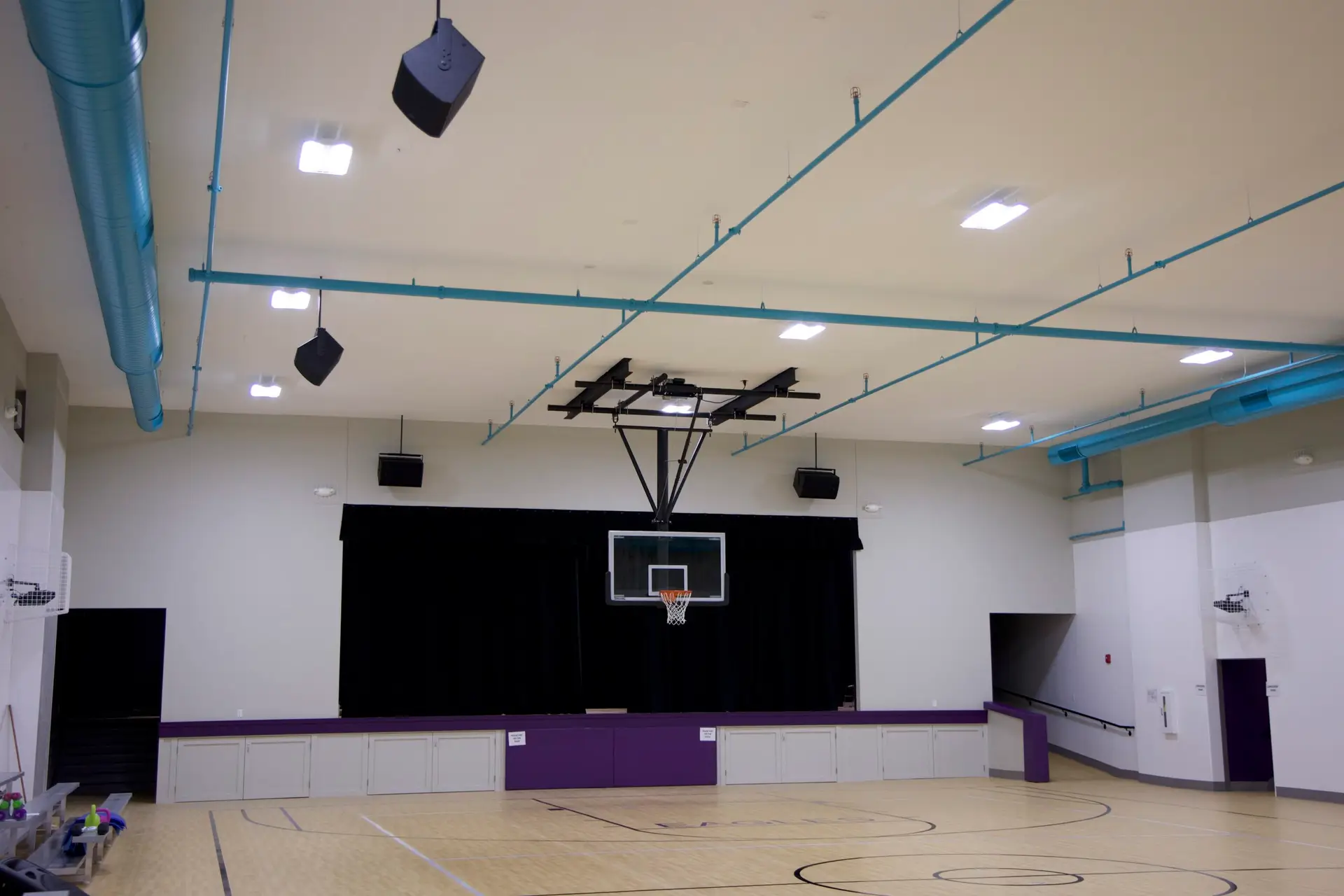 Wide view of Covenant Christian School gymnasium auditorium with installed speaker system