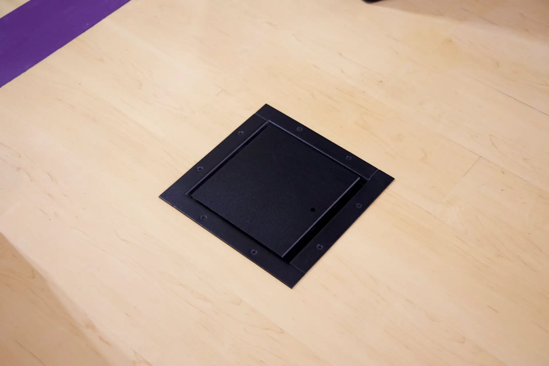 Closed Ace Backstage floor pocket installed in auditorium stage floor for clean connectivity